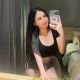 Attractive Malaysian woman taking a selfie. Malaysia escort.