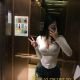 Megan, a Korea escort girl in Kuala Lumpur, poses for a selfie in an elevator.