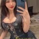 Attractive Malaysia escort girl, Maya, taking a selfie.