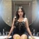 Attractive Malaysian escort girl, Maya, in a black dress.