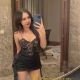 Attractive Malaysian escort girl, Maya, in a black dress.