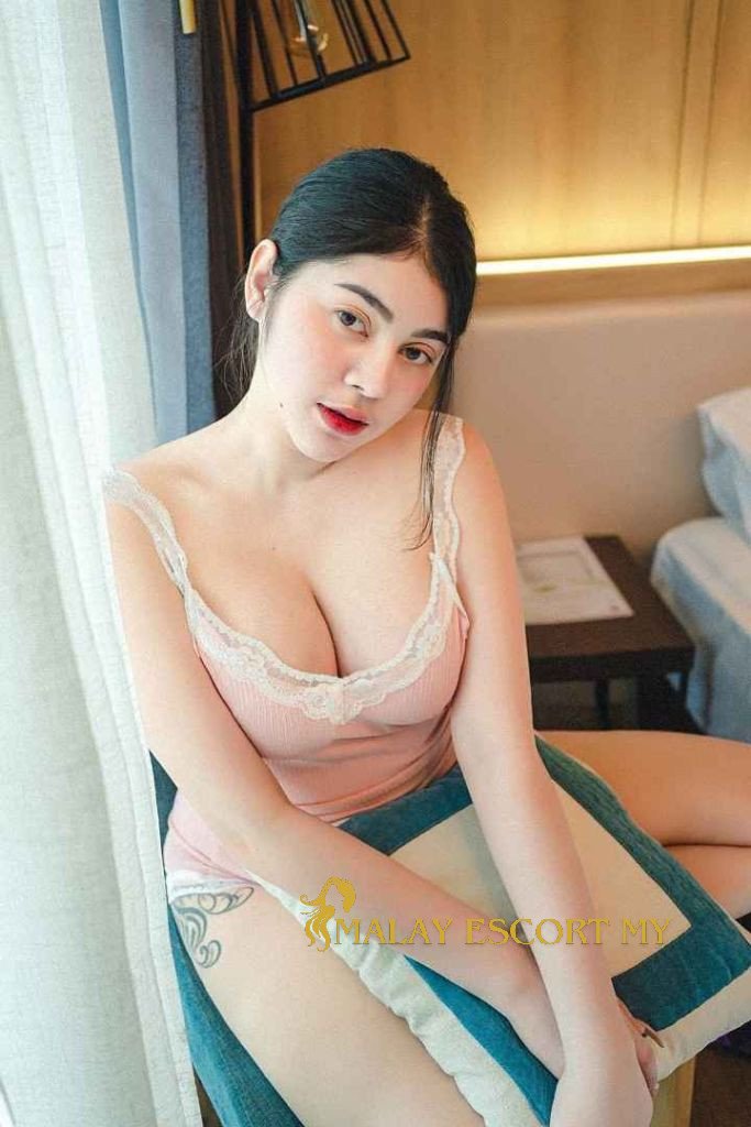 Attractive Malay woman in a pink camisole. Malay Escort My