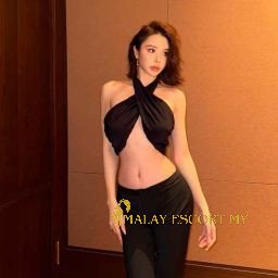 Attractive Malay woman in a black halter top and trousers. Malay Escort My