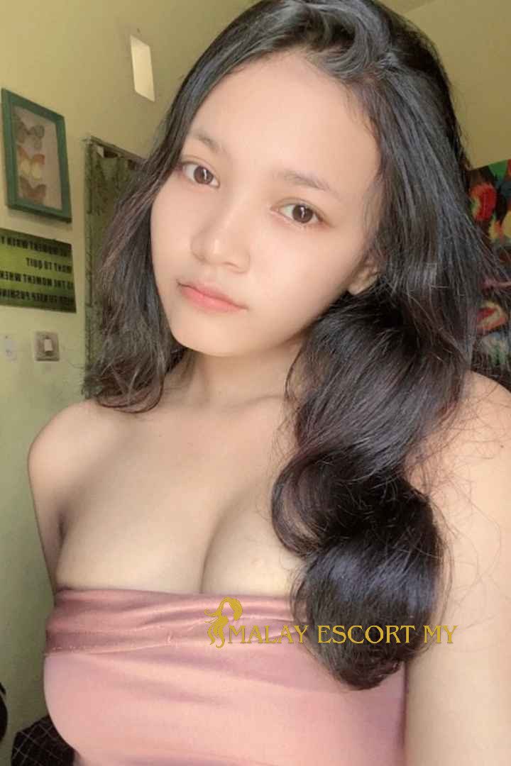 Attractive Malay woman in a pink top. Malay Escort My