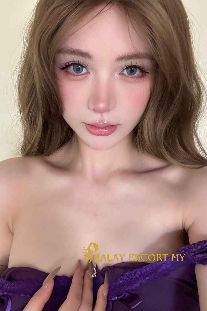 Attractive Malay woman in purple dress. Malay Escort My