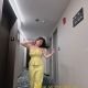 Divina, a Bukit Bintang escort, poses in a yellow jumpsuit.