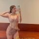 Divina, a Bukit Bintang escort, poses in a stylish two-piece outfit.