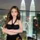 Hafizah, Kuala Lumpur escort, posing on a rooftop with KL skyline.