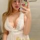 Attractive woman in white lace dress, KL escort services.