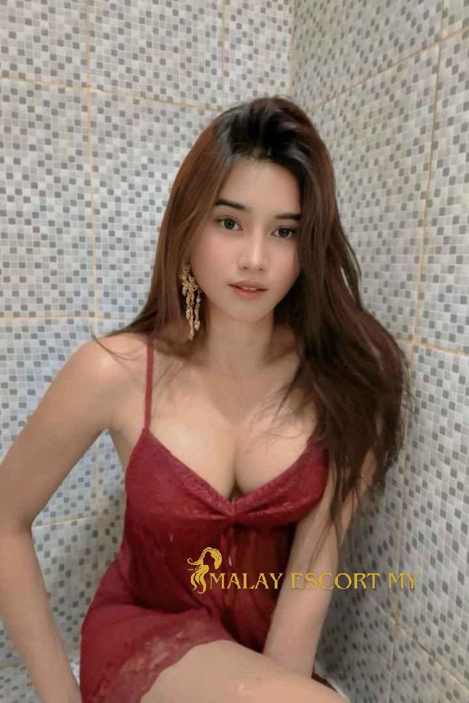 Attractive Malay woman in red dress. Malay Escort My