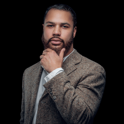 Thoughtful Michael, a man with a beard, hand on chin